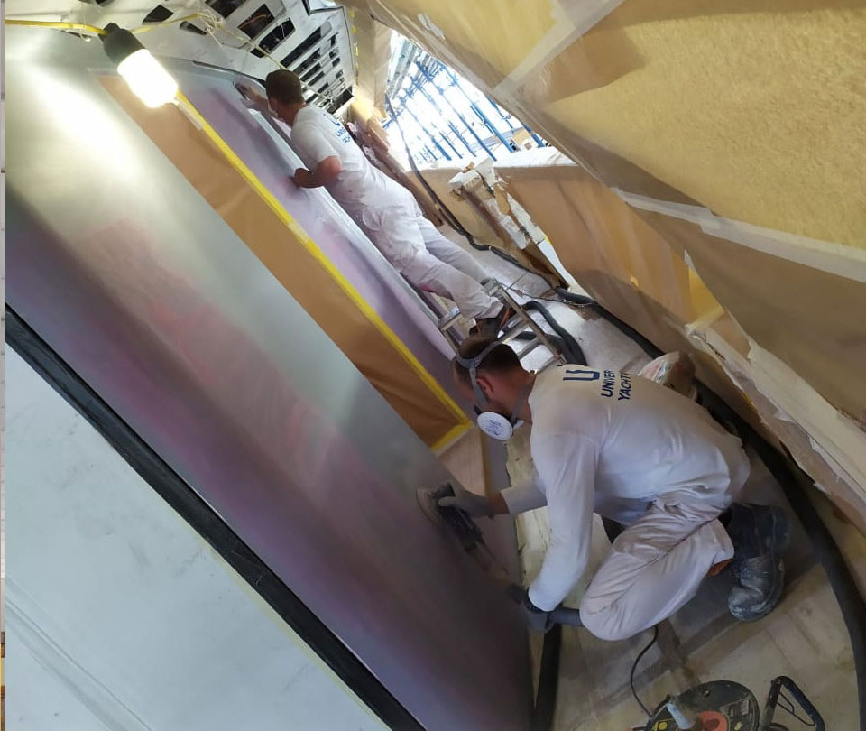 man-applying-filler-on-superyacht-surface