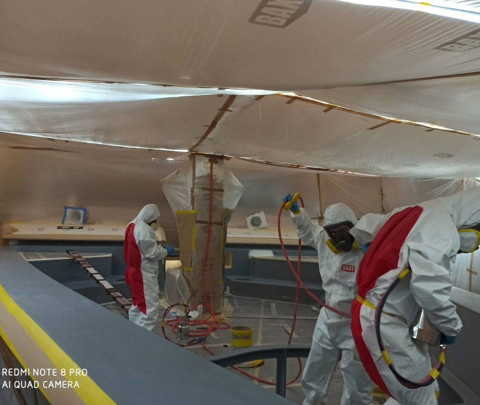 spray painters preparing to paint superyacht